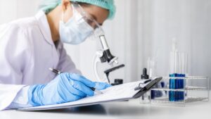 Laboratory worker conducting blood tests in larnaca, with lab equipment in the background.