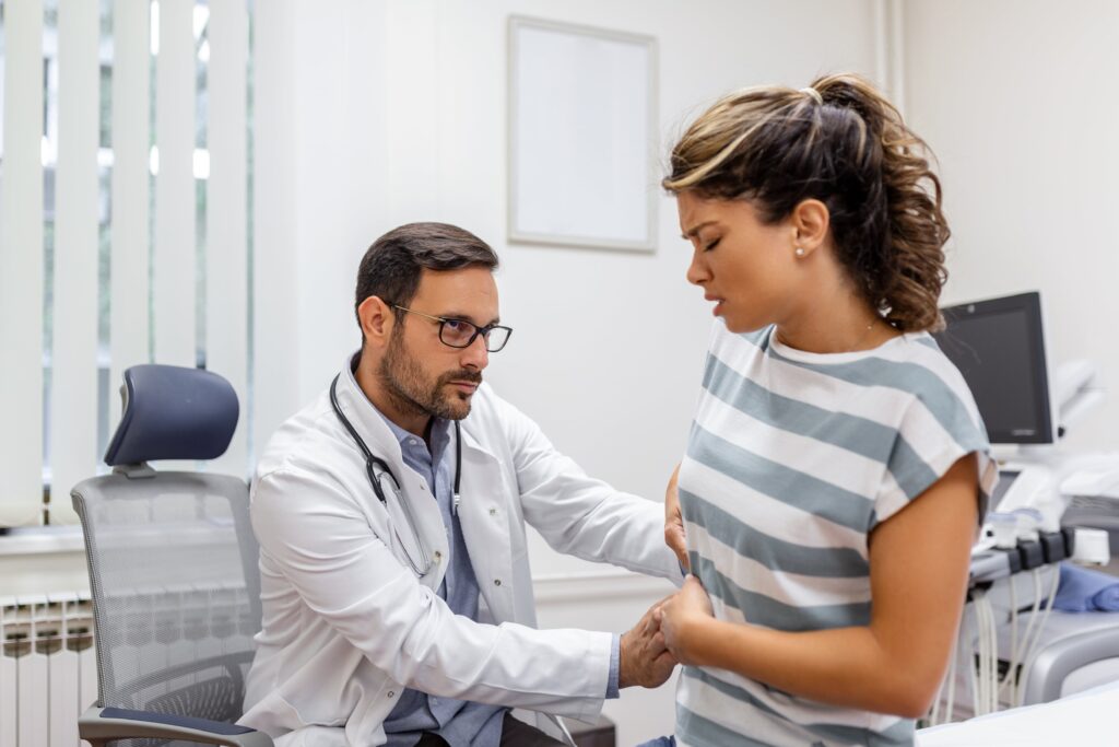 Healthcare professional consulting a fit woman in a clinic, representing personalized health care in Cyprus.
